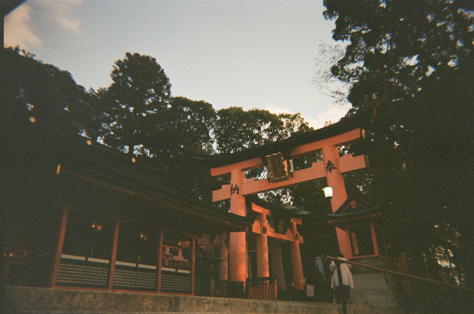 Praying for prosperity at the Fushimi Inari Taisha shrine located in Kyoto.</p>
<p>35mm film.